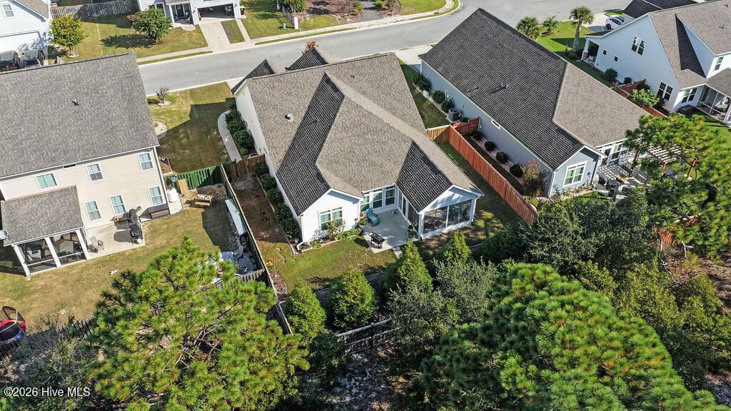 142 Rice Marsh Way Wilmington, NC 28412 - Photo 56 of 64 With its extended patio and enclosed 3-season room, this irrigated, beautifully landscaped sloping backyard is easy to maintain.