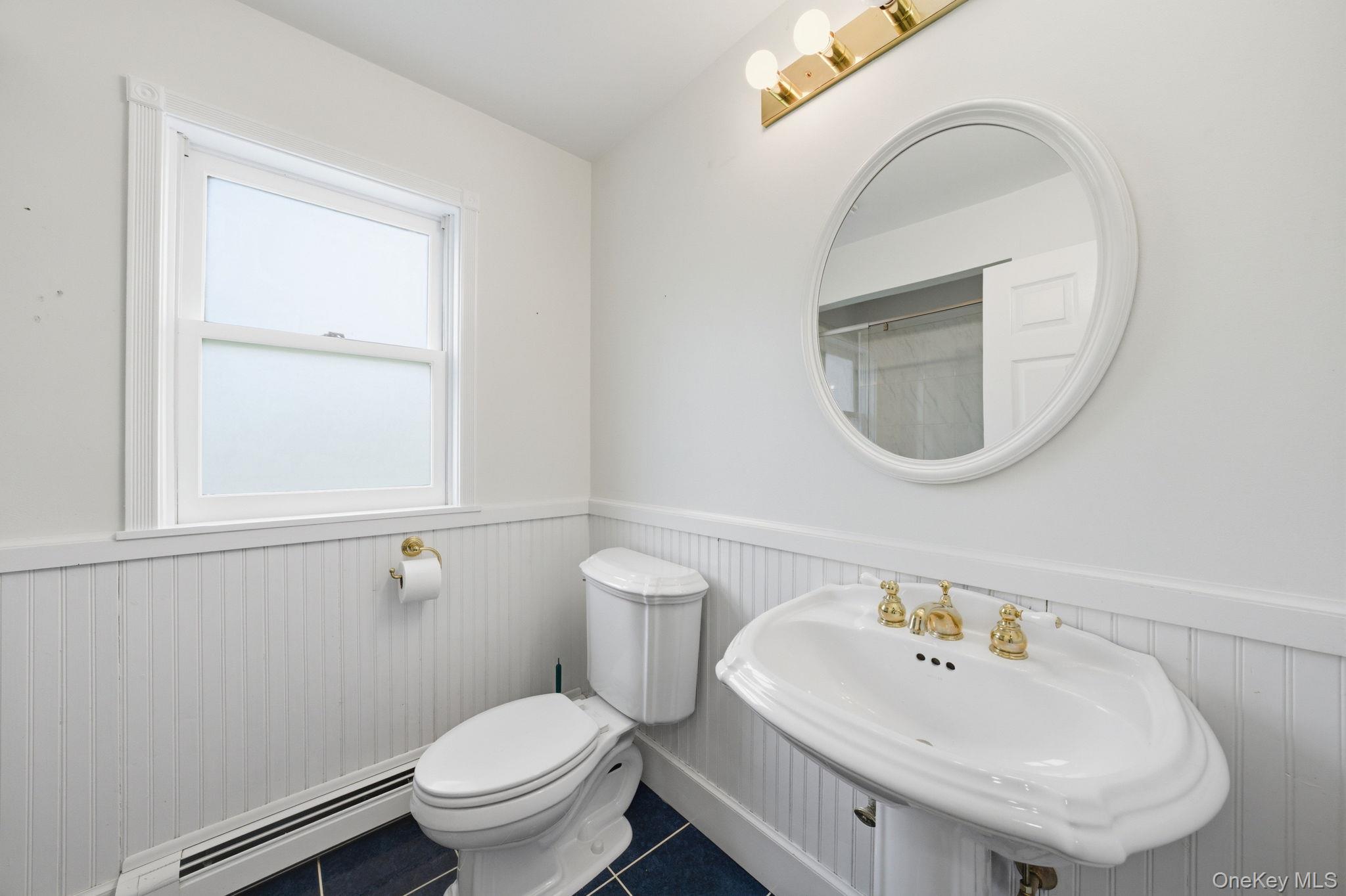83 Onderdonk Road Warwick, NY 10990 - Photo 12 of 40 a bathroom with a sink a toilet and a mirror