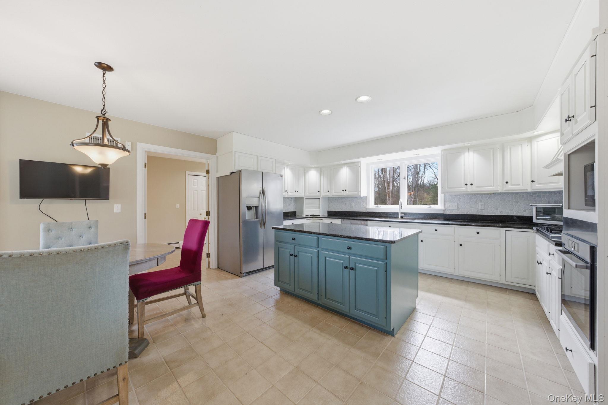 83 Onderdonk Road Warwick, NY 10990 - Photo 18 of 40 a kitchen with stainless steel appliances kitchen island granite countertop a sink and cabinets
