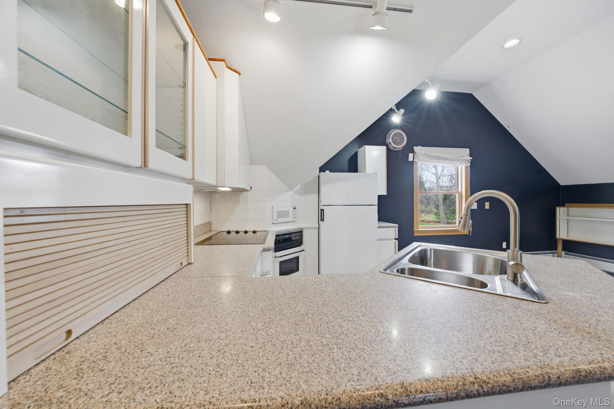 83 Onderdonk Road Warwick, NY 10990 - Photo 22 of 40 a kitchen with stainless steel appliances kitchen island a sink a stove and a refrigerator with wooden floor