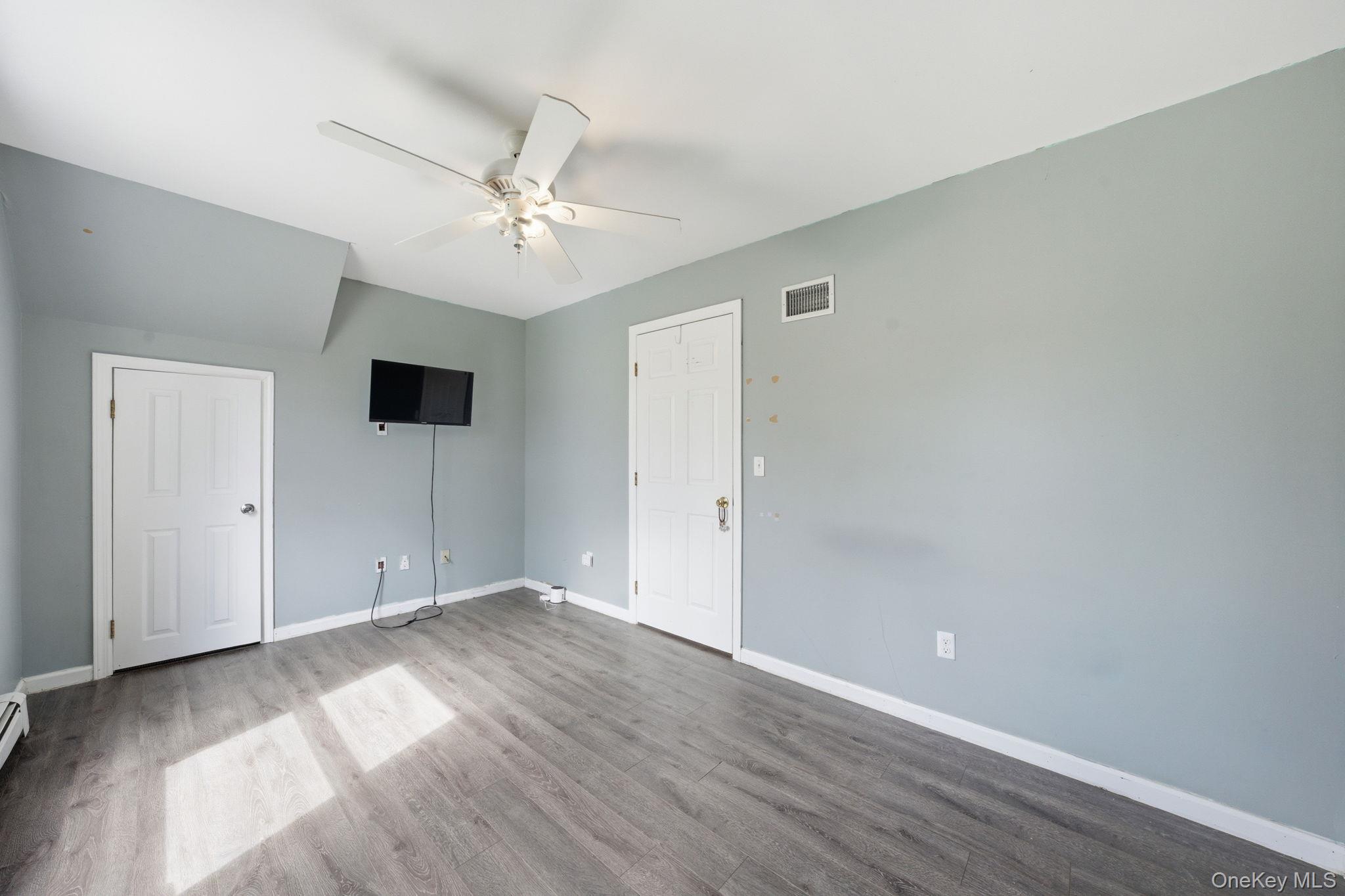 83 Onderdonk Road Warwick, NY 10990 - Photo 26 of 40 an empty room with wooden floor and ceiling fan