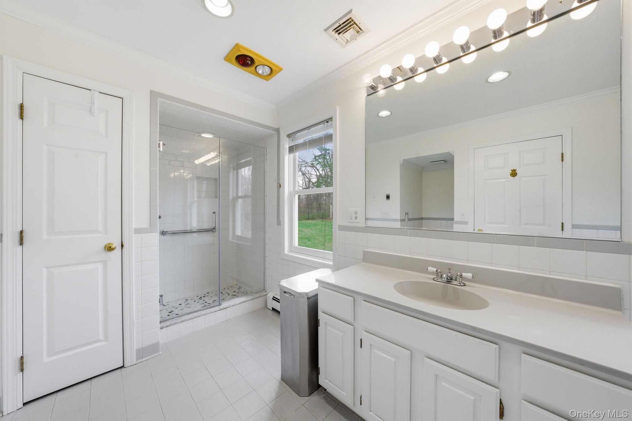 83 Onderdonk Road Warwick, NY 10990 - Photo 27 of 40 a bathroom with a sink a vanity a shower and a mirror