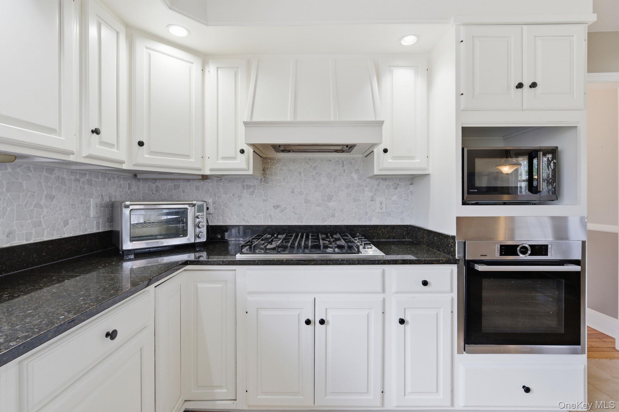 83 Onderdonk Road Warwick, NY 10990 - Photo 8 of 40 a kitchen with granite countertop white cabinets and stainless steel appliances