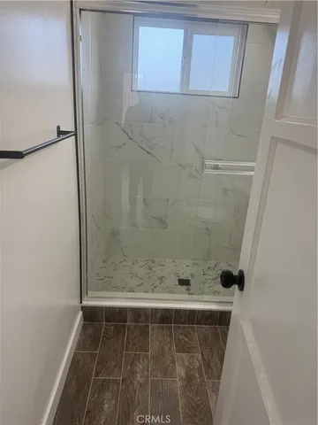 a pathway of a house with wooden fence