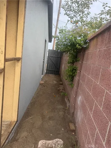 a view of empty room with window and chandelier fan