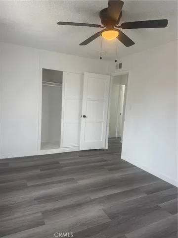 a bathroom with a toilet sink vanity and mirror