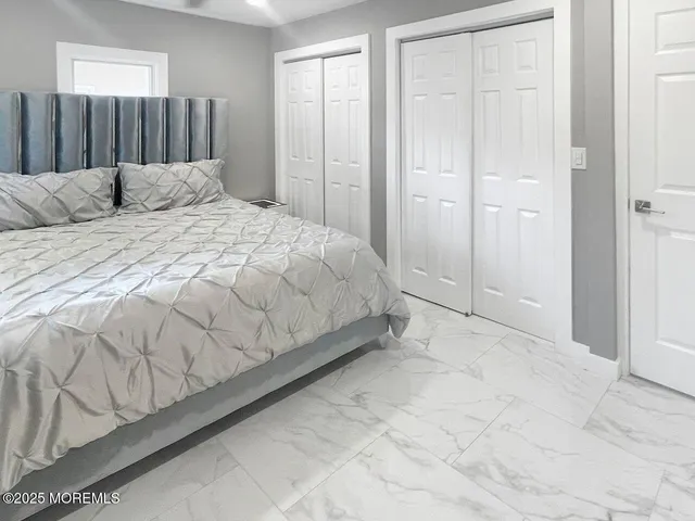 a bedroom with a bed and a mirror