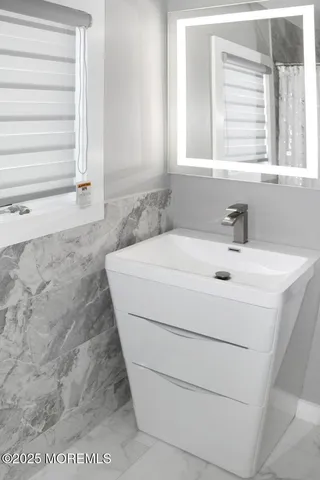 a bathroom with a sink and a window
