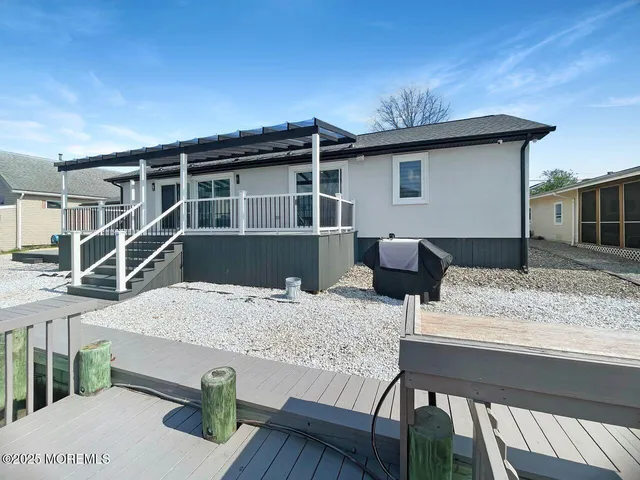 a roof deck with table and chairs