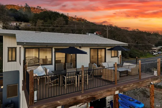 a view of a roof deck with table and chairs