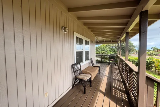 a view of balcony with chairs and wooden floor
