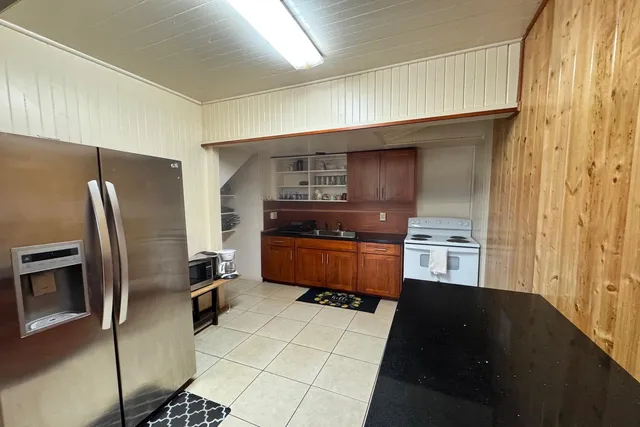 a kitchen with stainless steel appliances a refrigerator and a stove