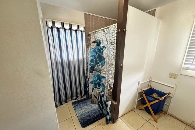 a view of a hallway with wooden floor and a window
