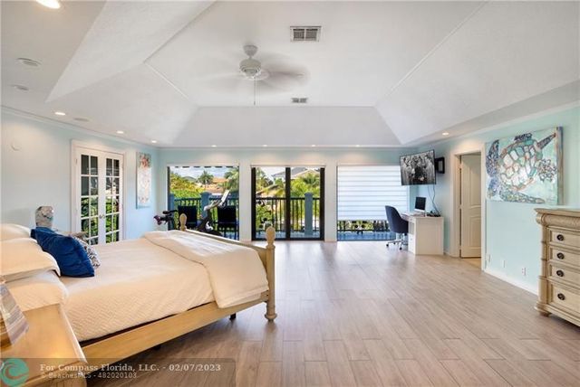 a spacious bedroom with a large bed and a large window