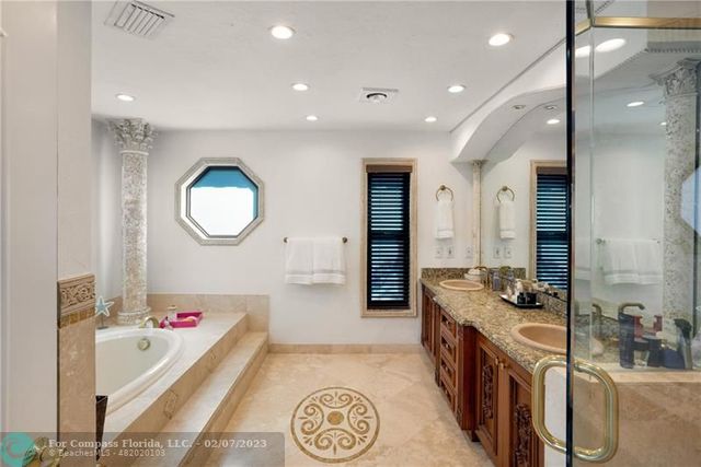 a bathroom with a tub sink and mirror