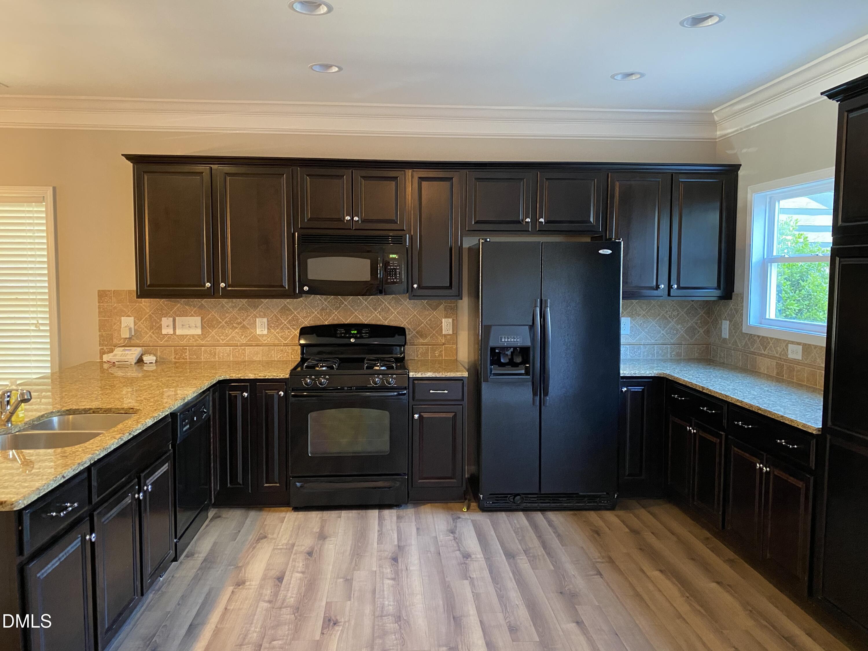 975 Branch Line Lane Apex, NC 27502 - Photo 2 of 12 a kitchen with a refrigerator stove and sink