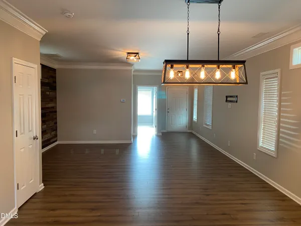 a view of a room with wooden floor and window