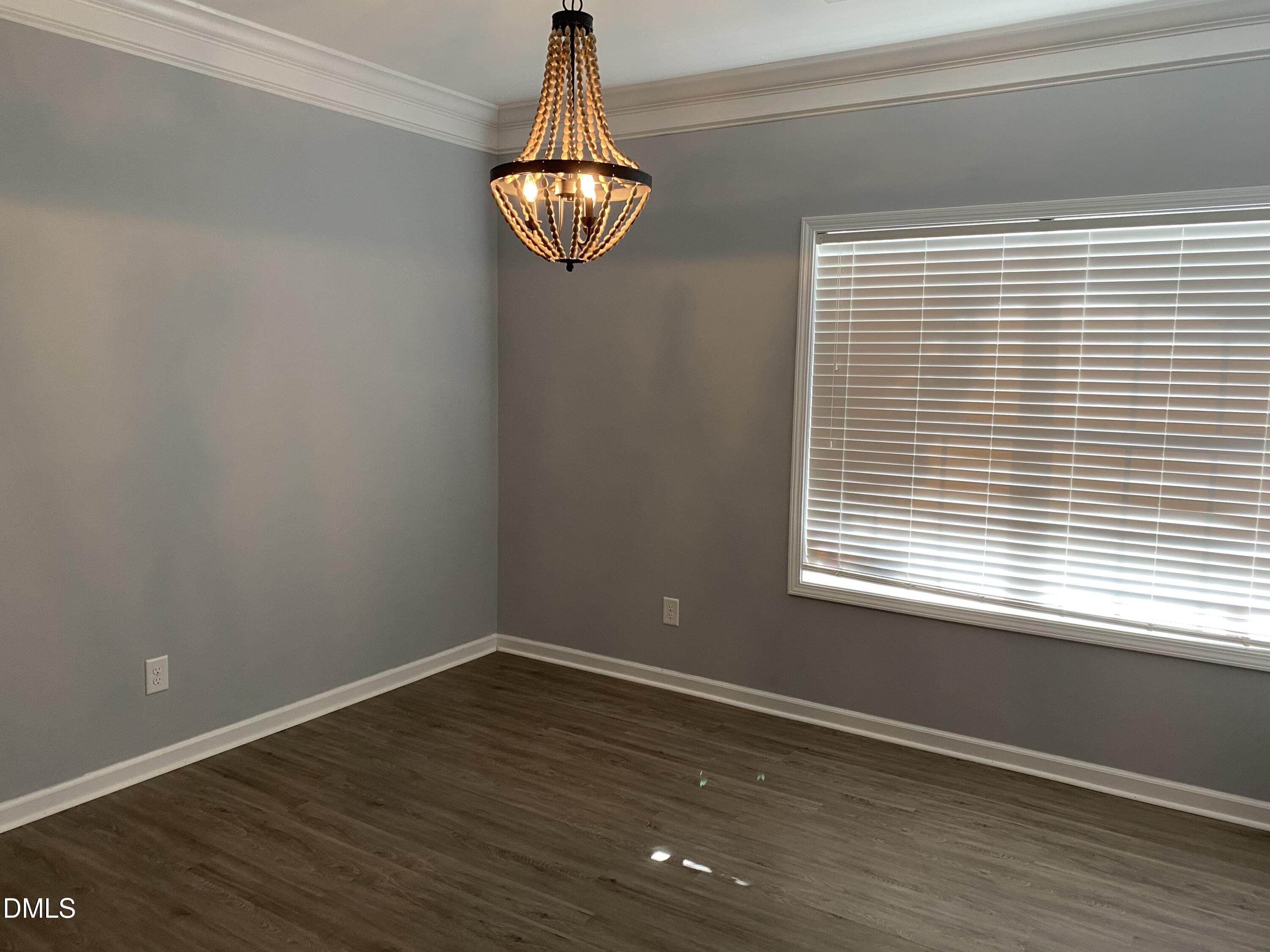 975 Branch Line Lane Apex, NC 27502 - Photo 6 of 12 a view of empty room with wooden floor and fan
