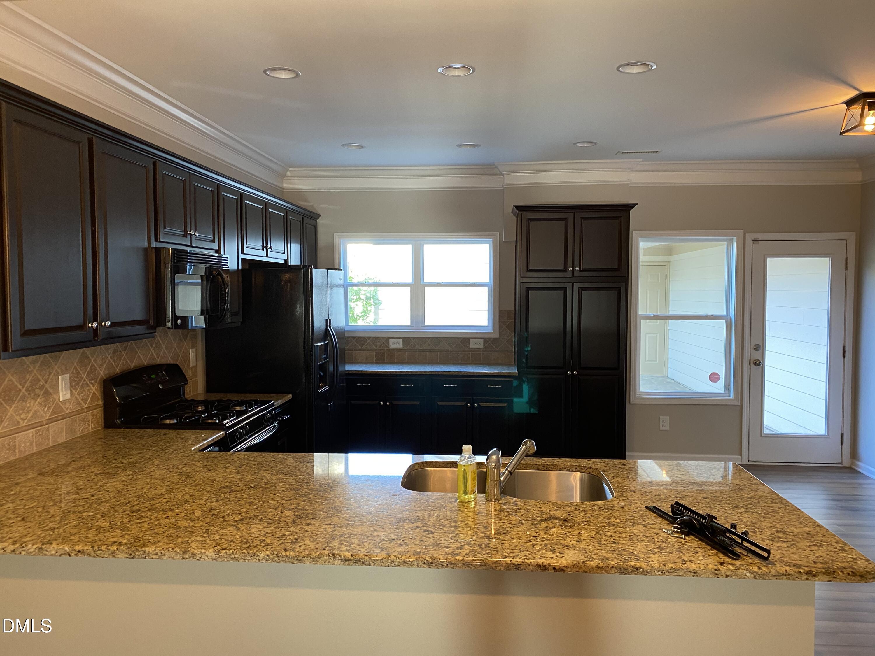 975 Branch Line Lane Apex, NC 27502 - Photo 7 of 12 a bathroom with a granite countertop sink and a mirror