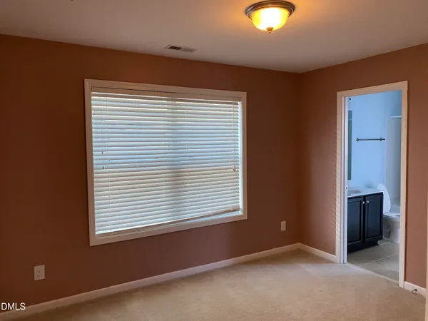 an empty room with window and closet