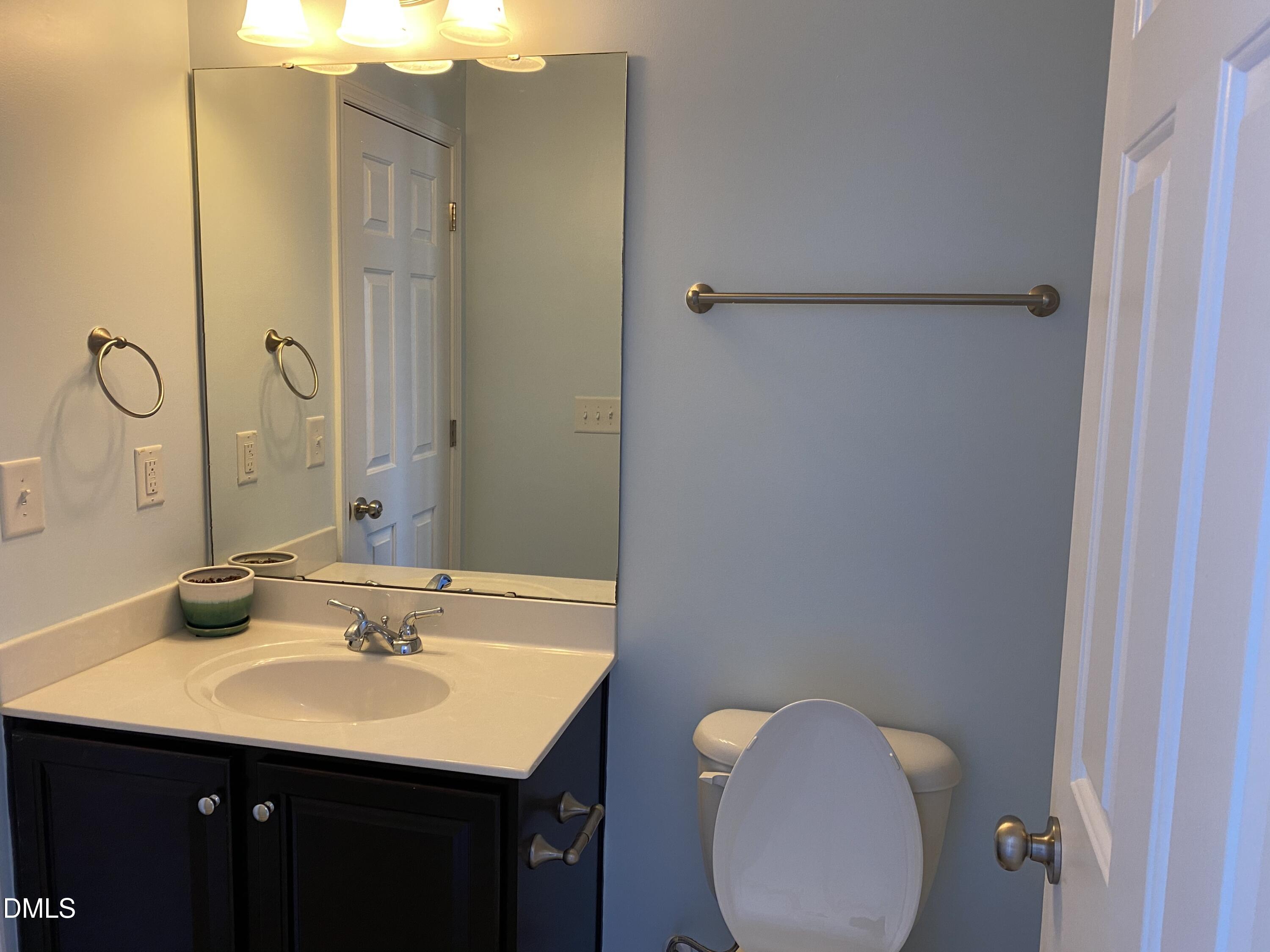 975 Branch Line Lane Apex, NC 27502 - Photo 9 of 12 a bathroom with a sink and mirror
