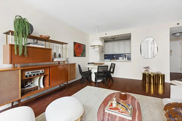 a living room with furniture a rug and a painting on the wall