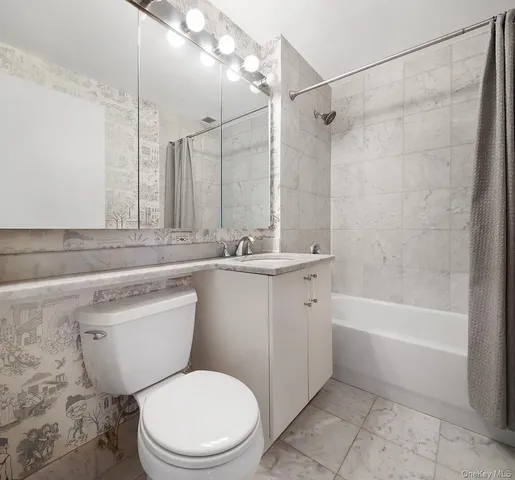 a bathroom with a sink a toilet a mirror and a shower