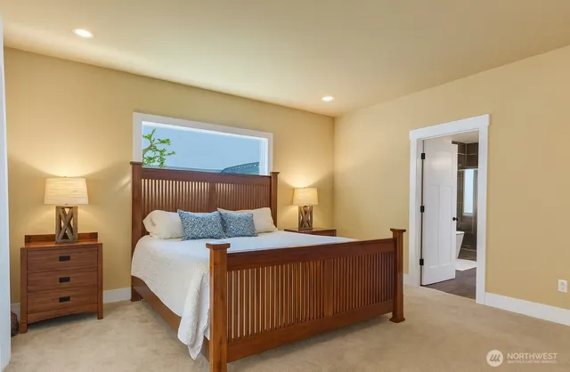 a bedroom with a bed and a night stand