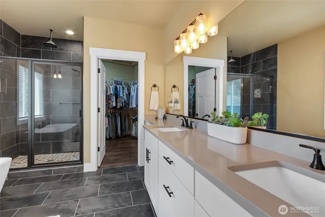 a bathroom with a double vanity sink and a mirror