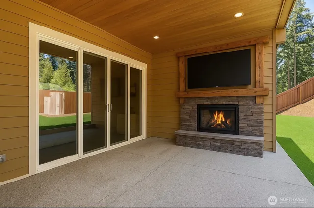 a living room with a fireplace and a flat screen tv