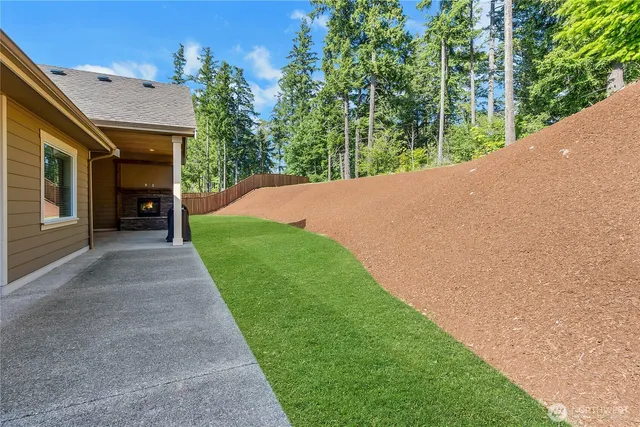 a view of a house with a yard and potted plants