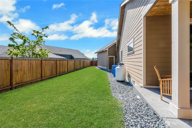 a view of a backyard with wooden fence