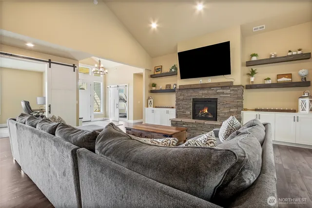 a living room with fireplace furniture and a flat screen tv