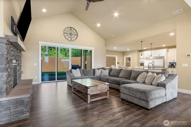 a living room with fireplace furniture and a flat screen tv