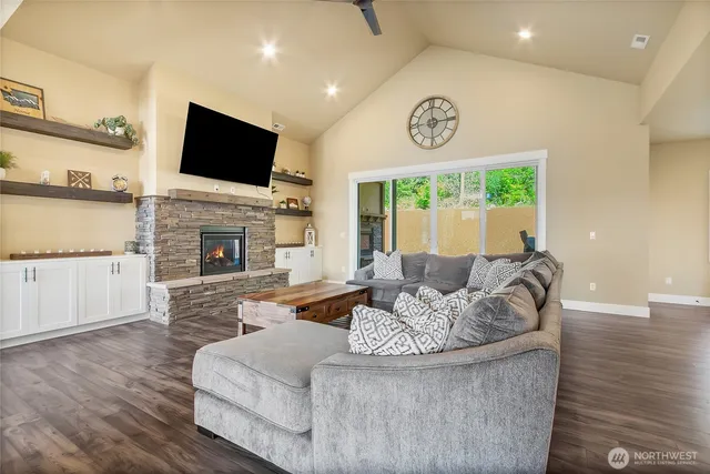 a living room with fireplace furniture and a flat screen tv
