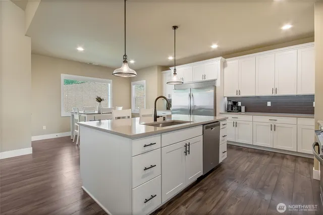 a kitchen with sink stove and cabinets