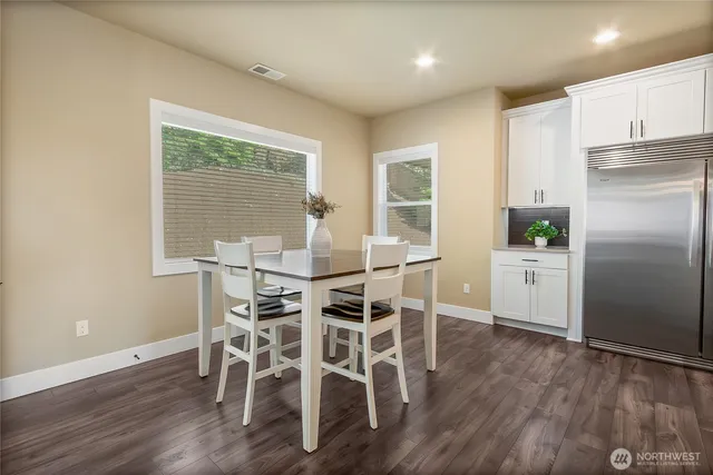 a dining room with furniture and wooden floor