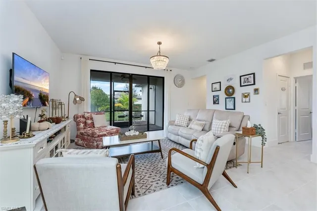 a living room with furniture fireplace and a large window