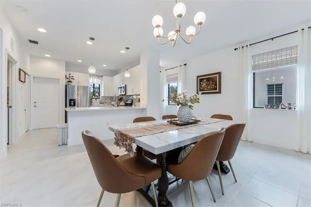 a view of a dining room with furniture and a chandelier