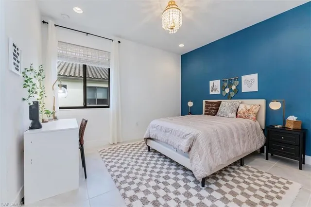 a bedroom with bed and window