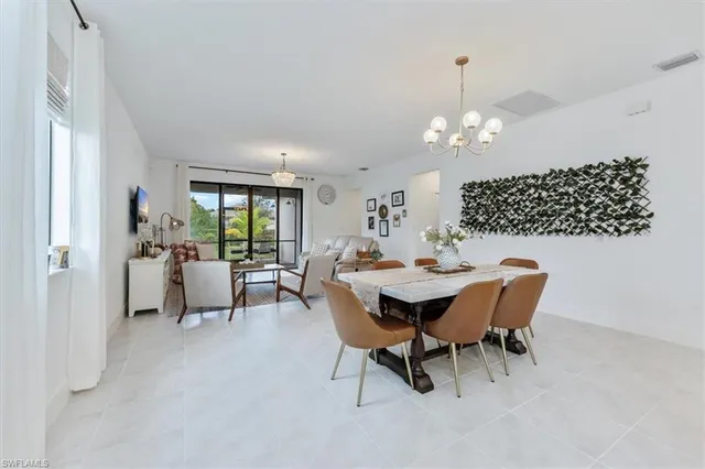 a living room with furniture chandelier and a table