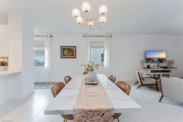 a living room with furniture fireplace and a large window