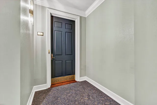 a kitchen with stainless steel appliances granite countertop a kitchen island a stove a refrigerator a sink a dining table and chairs with wooden floor