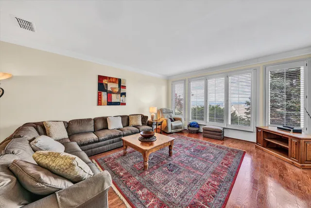 a view of a dining room with furniture large windows and wooden floor