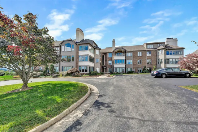 a view of a room that has a large window and front door