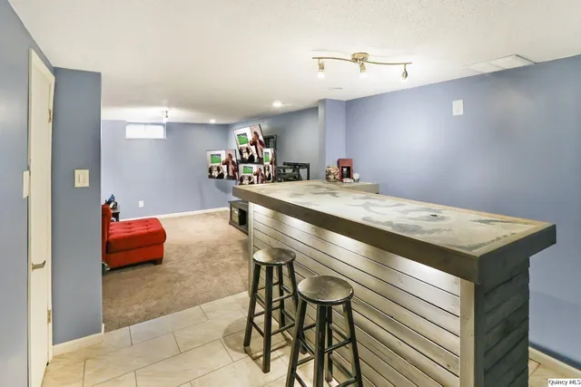 a dining hall with stainless steel appliances kitchen island a stove and a sink