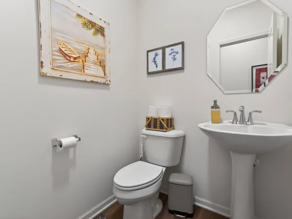 a bathroom with a toilet sink and mirror