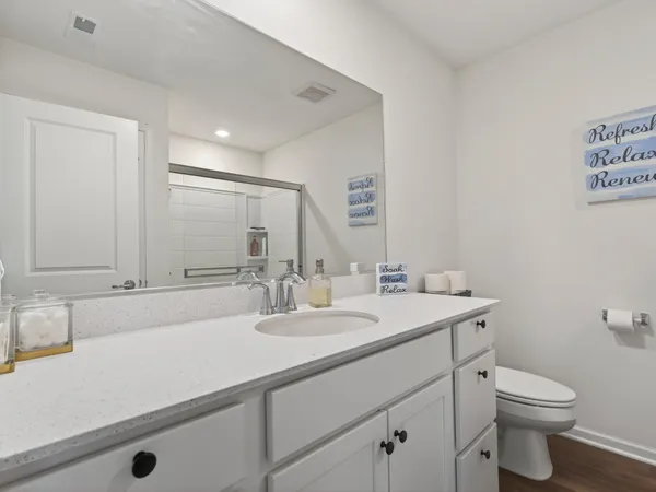 a bathroom with a sink toilet and mirror