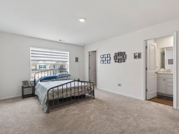 a bedroom with a bed and a view of bathroom