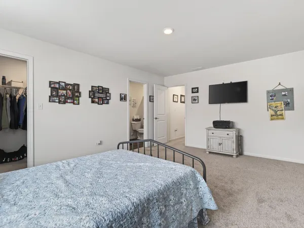 a bedroom with a bed and a television